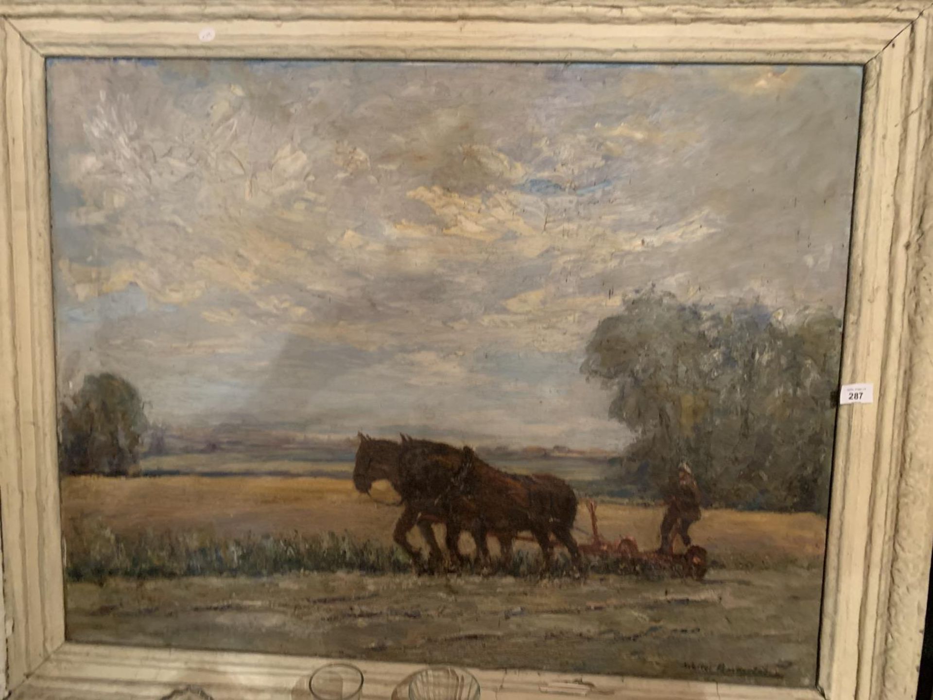 A LARGE FRAMED PAINTING OF HORSES PLOUGHING