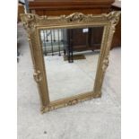 AN ELABORATE GILT FRAMED MIRROR