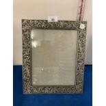 AN ORNATE WHITE METAL PHOTOGRAPH FRAME