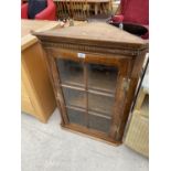 AN OAK FLAT FRONT CORNER CABINET