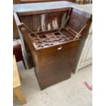 A MAHOGANY COCKTAIL CABINET WITH CANTILEVER RISE AND FALL TOP, TWO LOWER DOORS AND BRASS FITTINGS