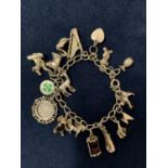 A SILVER CHARM BRACELET WITH SEVENTEEN CHARMS