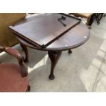 A MAHOGANY WIND OUT DINING TABLE ON CABRIOLE SUPPORTS