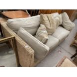 A WOVEN TWO SEATER CONSERVATORY SOFA AND MATCHING TABLE