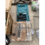 A TILE CUTTER (IN WORKING ORDER) AND A MAKITA DRILL IN A CASE