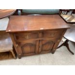 A SMALL OAK SIDEBOARD WITH TWO DOORS AND TWO DRAWERS
