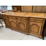 A FRENCH OAK SIDEBOARD WITH FOUR DOORS AND FOUR DRAWERS