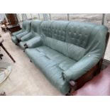 A GREEN LEATHER THREE SEATER SOFA AND TWO ARMCHAIRS