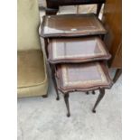 A MAHOGANY NEST OF TABLES WITH LEATHER TOPS