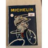 A VINTAGE STYLE CAST MICHELIN MAN ON A BIKE SIGN