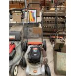 A FLYMO PETROL MOWER - ENGINE RUNS WELL IN GEAR NO NEUTRAL ONE WHEEL DETACHED