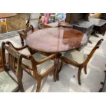 AN INLAID MAHOGANY EXTENDING DINING TABLE WITH TWO DINING CHAIRS AND TWO CARVERS