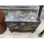 AN ORIENTAL JAPANNED CHEST WITH BRASS CLASP AND ELABORATE DECORATION