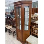 A CHERRY WOOD CABINET WITH LOWER DOOR AND UPPER GLAZED DOOR