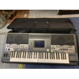 A YAMAHA PSR 9000 KEYBOARD WITH CARRYING BAG AND MUSIC DESK. 61 KEYS BUILT IN SPEAKERS AND FITTED