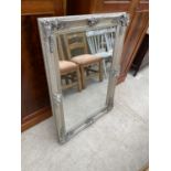 AN ELABORATE SILVER GILT FRAMED MIRROR