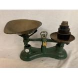 A GREEN SET OF SALTER SCALES WITH BRASS PANS AND WEIGHTS