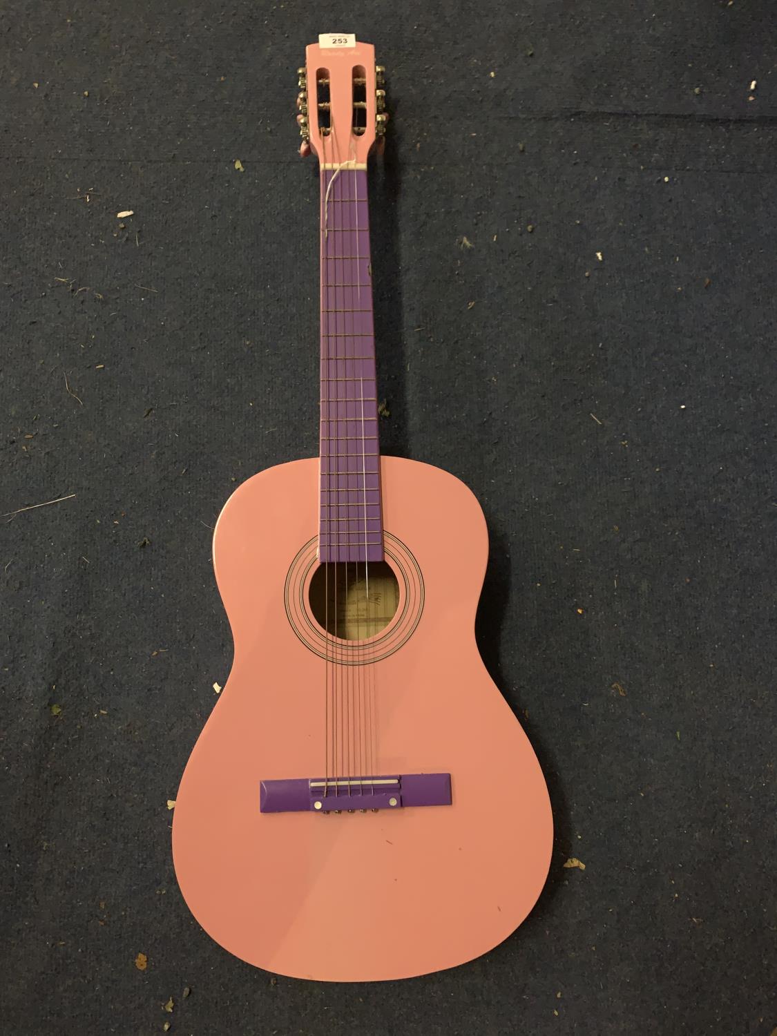 A PINK AND PURPLE ACOUSTIC GUITAR