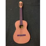 A PINK AND PURPLE ACOUSTIC GUITAR