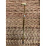 A WALKING STICK WITH A BONE HANDLE AND A POSSIBLY SILVER FINIAL