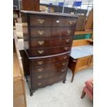 A REPRODUCTION BOW FRONT MAHOGANY CHEST ON CHEST WITH EIGHT DRAWERS
