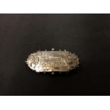 A SILVER AUDLEM CHURCH BROOCH