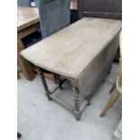 AN EARLY TWENTIETH CENTURY OAK BARLEY TWIST GATE LEG TABLE