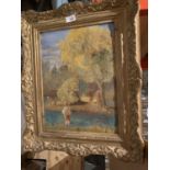 A GILT FRAMED OIL ON CANVAS OF PEOPLE BY RIVER SCENE