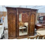 A VICTORIAN WALNUT BREAK FROM TRIPLE WARDROBE WITH CENTRE MIRROR DOOR, ENCLOSING DRESSING SLIDES,