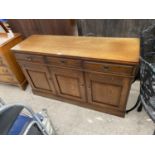 AN OAK SIDEBOARD WITH THREE DOORS AND THREE DRAWERS