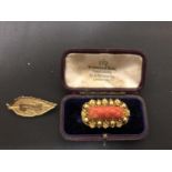 A CORAL AND YELLOW METAL BROOCH AND A FURTHER YELLOW METAL BROOCH