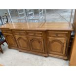 A FRENCH OAK SIDEBOARD WITH FOUR DOORS AND FOUR DRAWERS