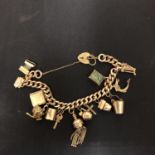A 9CT GOLD CHARM BRACELET WITH 14 CHARMS, 44.8G