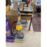 A YELLOW DYSON VACUUM CLEANER