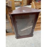 A MAHOGANY CORNER CUPBOARD WITH SINGLE GLAZED DOOR