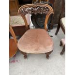 A VICTORIAN MAHOGANY CHILD'S CHAIR ON PORCELAIN CASTERS WITH PIERCED TOP RAIL