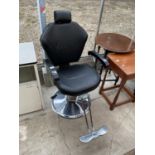 A BLACK AND CHROME SWIVEL BARBER'S CHAIR