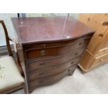 A REPRODUCTION MAHOGANY SERPENTINE CHEST OF FOUR DRAWERS AND DRESSING SLIDE