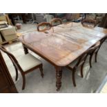 A VICTORIAN MAHOGANY EXTENDING DINING TABLE AND EIGHT MAHOGANY BALLOON BACK CHAIRS