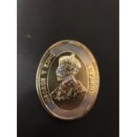 AN OVAL SILVER AND GOLD GEORGE V MEDALLION