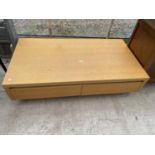 A LOW OAK COFFEE TABLE ENCLOSING FOUR DRAWERS