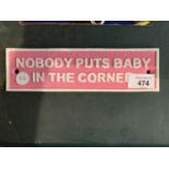 A NOBODY PUTS BABY IN THE CORNER CAST METAL SIGN