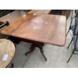 A VICTORIAN MAHOGANY PEDESTAL DROP LEAF DINING TABLE