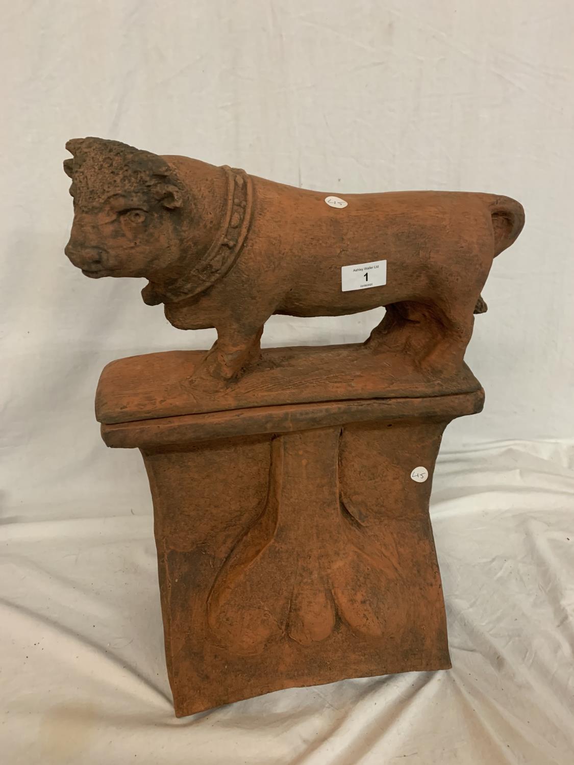 A TERRACOTTA STONE RIDGE TILE WITH DETACHABLE BULL SURMOUNT