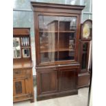 A 19TH CENTURY MAHOGANY CABINET WITH TWO LOWER DOORS AND UPPER GLAZED PANEL DOOR