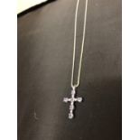 A 9CT WHITE GOLD TANZANITE AND DIAMOND CROSS PENDANT WITH A WHITE METAL CHAIN (UNMARKED), APPROX