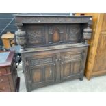 A HEAVILY CARVED OAK COURT CUPBOARD WITH TWO LOWER AND TWO UPPER DOORS