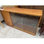 A TEAK BOOKCASE CABINET WITH ONE DOOR AND TWO SLIDING GLASS DOORS