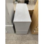 A THREE DRAWER METAL FILING CABINET