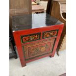 AN ORIENTAL PAINTED CABINET WITH ONE DOOR, TWO DRAWERS AND FLORAL DECORATION